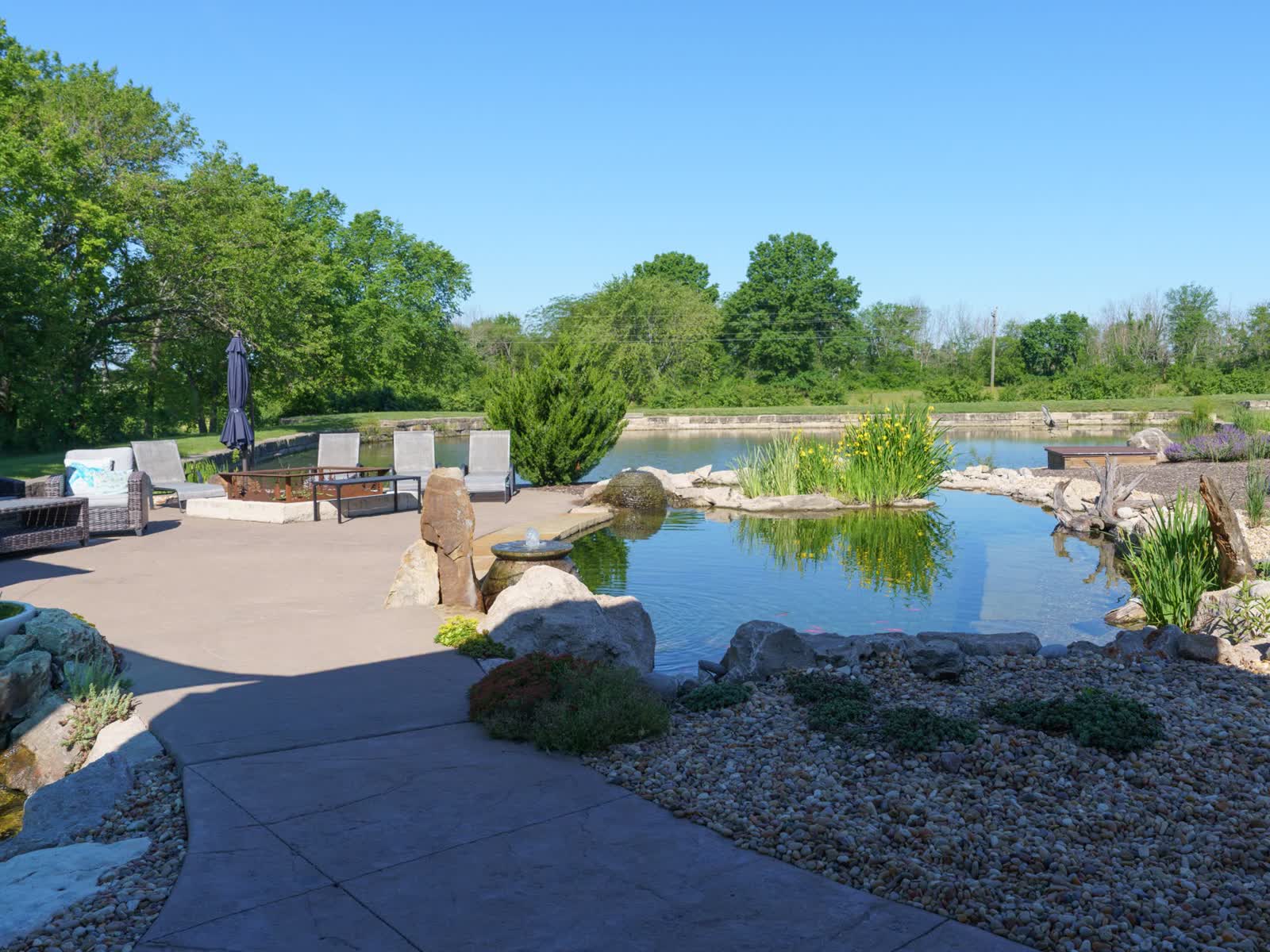 Custom koi pond with natural stone waterfall in Kansas City backyard